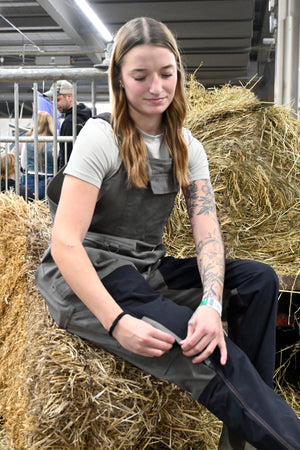 Tradeswoman wearing Zenith grey women’s work overalls on job site