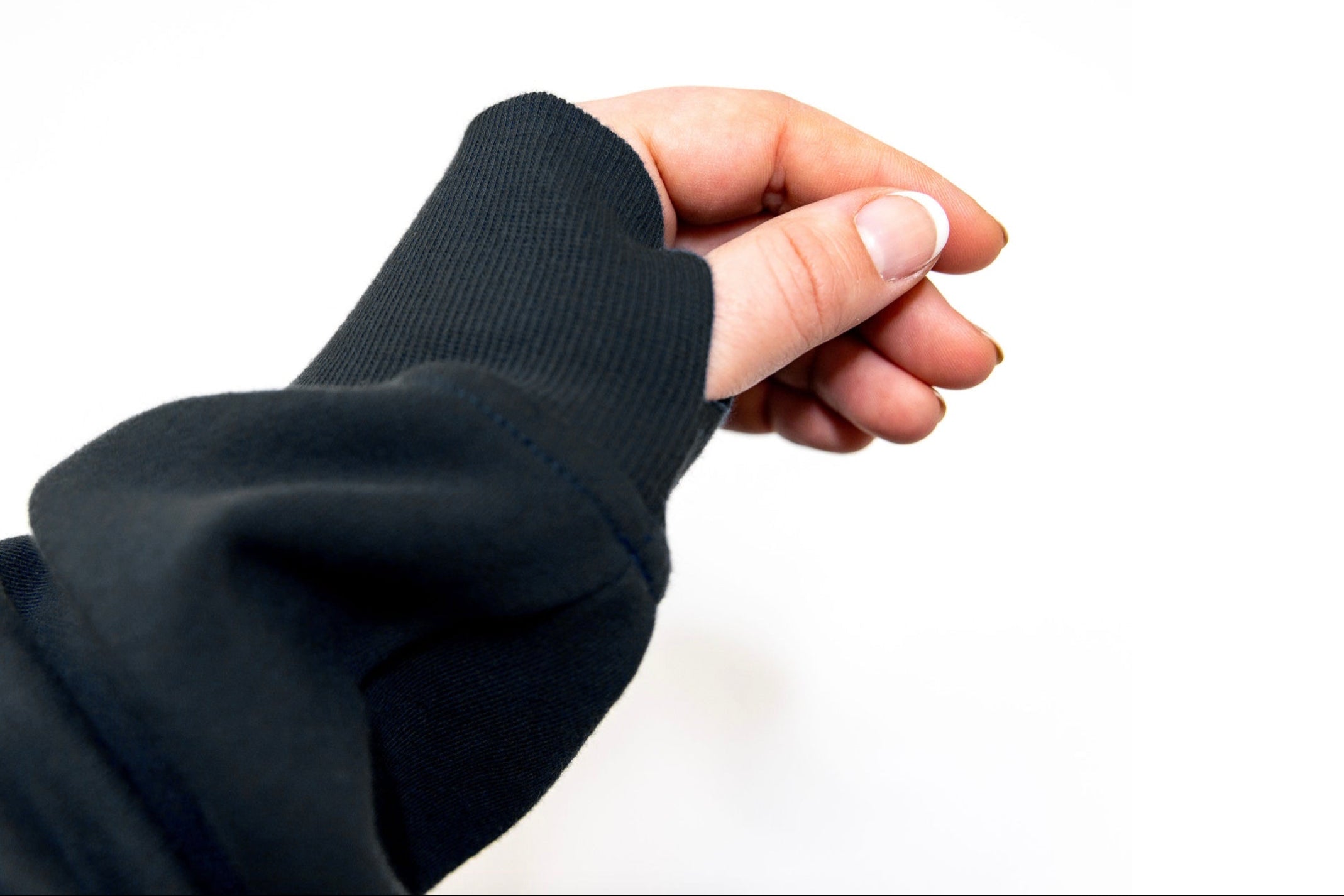 Hand wearing a black sleeve against a white background